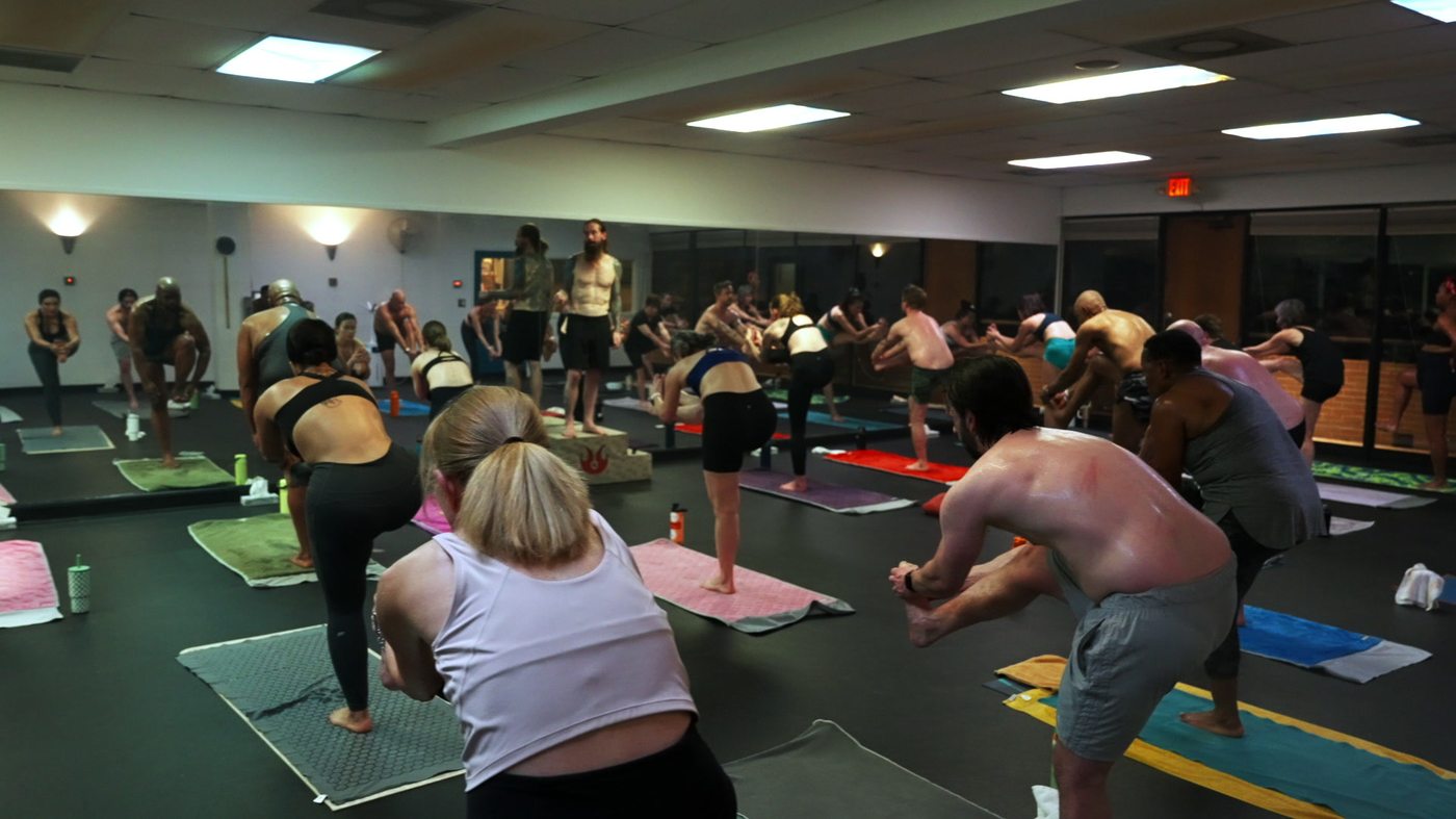 Students doing a balancing pose at Still Hot Yoga